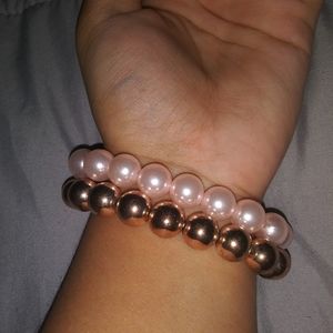 2 faux pearl bracelets.
